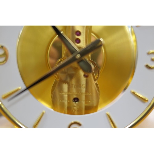 667 - Jaeger Le Coultre brass Atmos clock, mid 1970s, having a white chapter ring with Arabic and baton nu... 