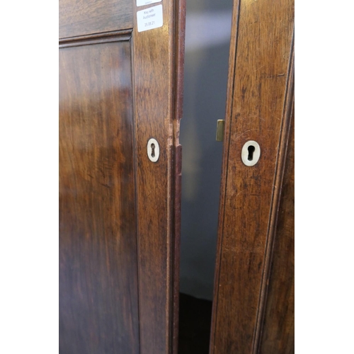 695 - Late George III mahogany press wardrobe, circa 1800-20, moulded cornice over two double recessed pan... 