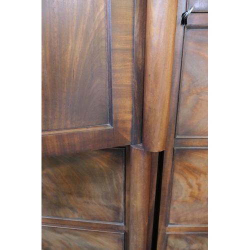 744 - William IV mahogany breakfront press cupboard, circa 1835, centred with two flame mahogany panel doo... 