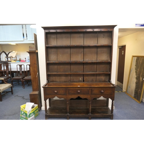 747 - Late George III oak dresser and plate rack, circa 1800, the boarded rack with three shelves and thre... 