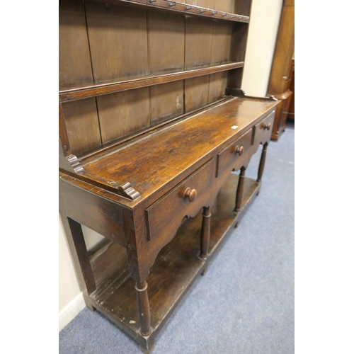 747 - Late George III oak dresser and plate rack, circa 1800, the boarded rack with three shelves and thre... 