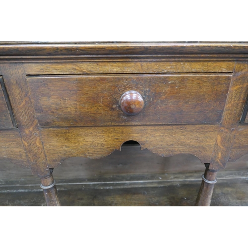 747 - Late George III oak dresser and plate rack, circa 1800, the boarded rack with three shelves and thre... 