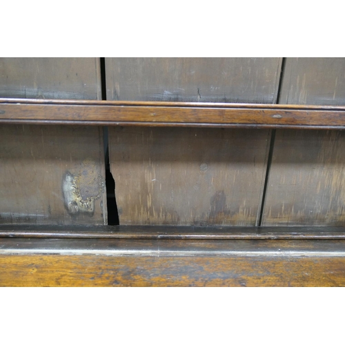 747 - Late George III oak dresser and plate rack, circa 1800, the boarded rack with three shelves and thre... 