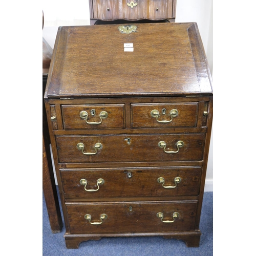 697 - Small oak bureau, 19th Century conversion, having a slope front opening to an interior with cupboard... 