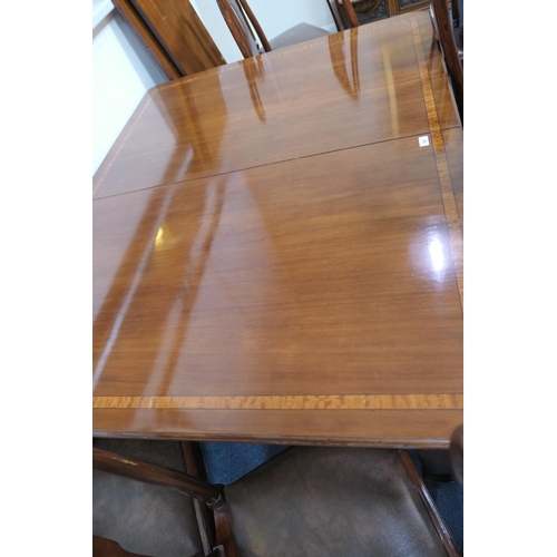 761 - Late Victorian mahogany satinwood banded wind out dining table, with two additional leaves, raised o... 