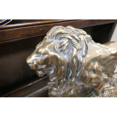 654 - After Barye, a polished bronze sculpture of a lion, the base bearing a signature, height 26cm, lengt... 