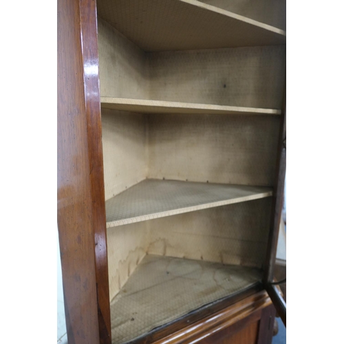 705 - Mahogany glazed freestanding corner cabinet, 19th Century, having a swan neck pediment centred with ... 