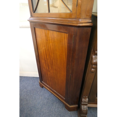 705 - Mahogany glazed freestanding corner cabinet, 19th Century, having a swan neck pediment centred with ... 