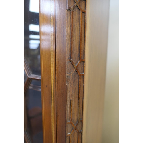 706 - Late George III mahogany and inlaid bookcase cabinet, circa 1790-1810, of small proportions, surmoun... 