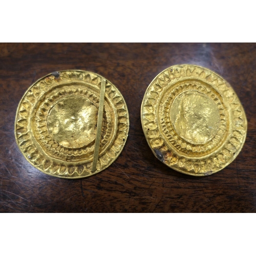 370 - Pair of antique gold mounts, circular form centred with a mask of Zeus, within a radial punched bord... 