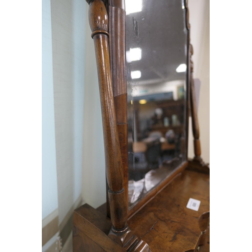 688 - Walnut dressing mirror, early 18th Century, having a shaped bevelled glass plate within a cushion mo... 