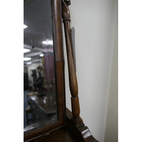 688 - Walnut dressing mirror, early 18th Century, having a shaped bevelled glass plate within a cushion mo... 