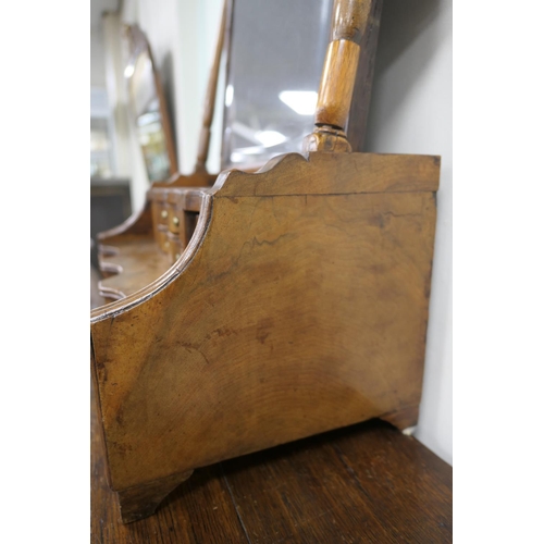 688 - Walnut dressing mirror, early 18th Century, having a shaped bevelled glass plate within a cushion mo... 