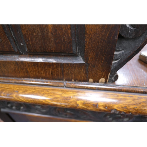 696 - Victorian Flemish carved oak cabinet, the upper part with two cupboard doors, each with carved doubl... 