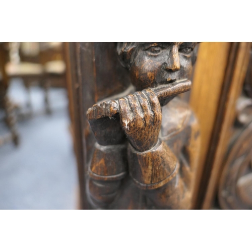 696 - Victorian Flemish carved oak cabinet, the upper part with two cupboard doors, each with carved doubl... 