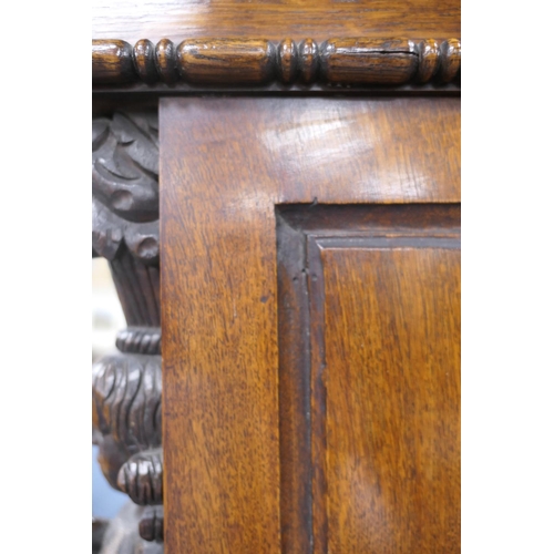 696 - Victorian Flemish carved oak cabinet, the upper part with two cupboard doors, each with carved doubl... 