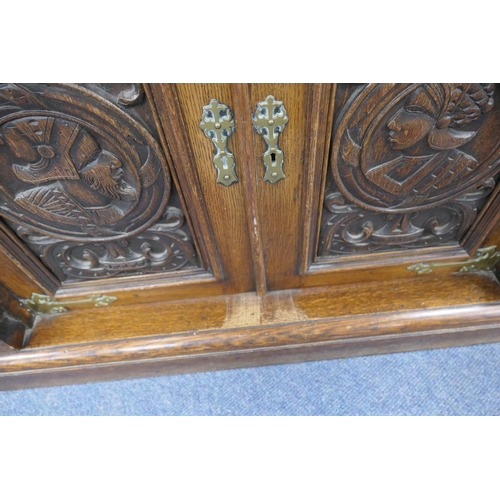 696 - Victorian Flemish carved oak cabinet, the upper part with two cupboard doors, each with carved doubl... 