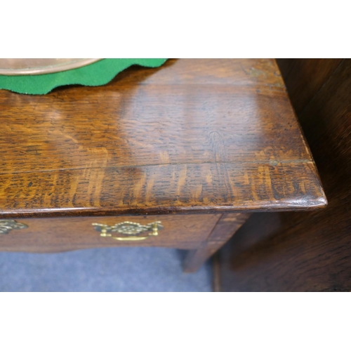 717 - George III oak low dresser, circa 1760-80, having three drawers with moulded edge, brass fretwork sw... 