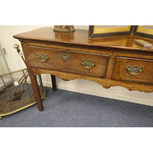 717 - George III oak low dresser, circa 1760-80, having three drawers with moulded edge, brass fretwork sw... 