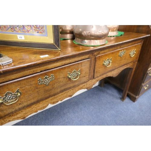 717 - George III oak low dresser, circa 1760-80, having three drawers with moulded edge, brass fretwork sw... 