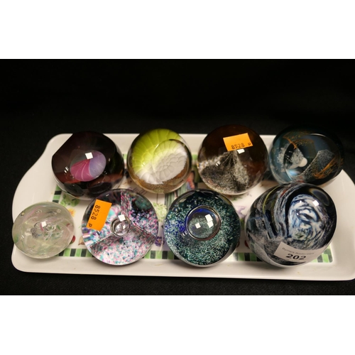 202 - Six Caithness glass paperweights and two further glass paperweights (8)