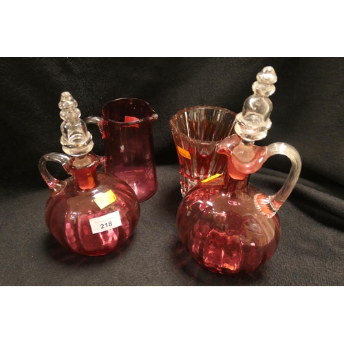 218 - Victorian cranberry glass claret jug, further cranberry claret jug, cranberry jug and a Saint-Louis ... 