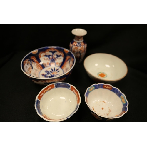 245 - Three Japanese Imari bowls and a Japanese Imari small vase; also a Canton footed bowl (5)