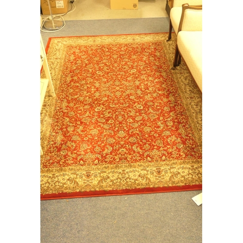 491 - Machine made deep red ground woollen rug, size 229cm x 159cm