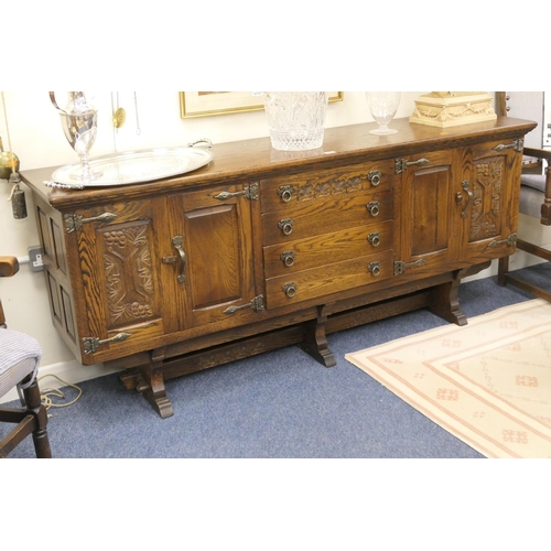 535 - Oak harlequin dining room suite comprising refectory style carved oak table with cup and cover suppo... 