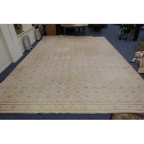 682 - Large machine made fawn ground woollen carpet, size 5.5m x 4m