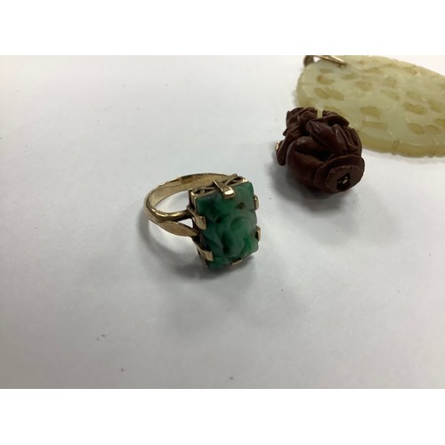 384 - Oriental carved jadeite dress ring in unmarked yellow gold, gross weight 4.3g; also an Oriental monk... 