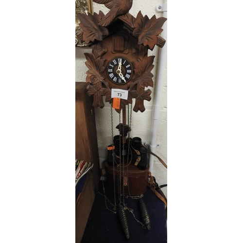 73 - Wooden framed and carved cuckoo clock; also a pair of J. T. Coppock, Paris binoculars, cased (2)