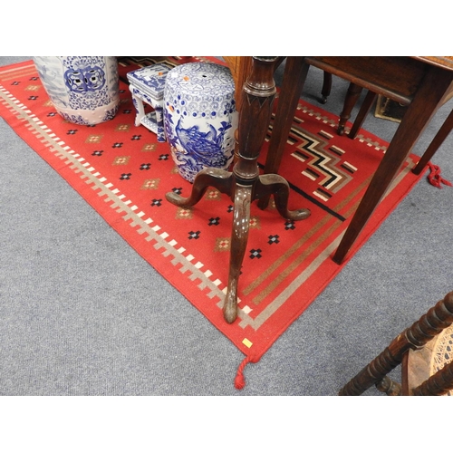 665 - Red ground tribal rug, probably American, 216cm x 135cm