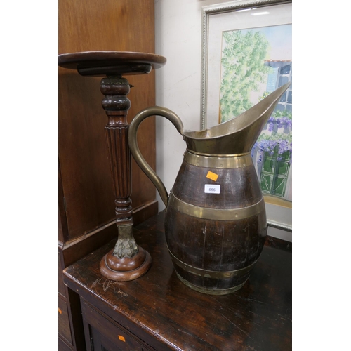 556 - Mahogany and brass mounted monoped torchere, also a brass coopered oak water jug (2)