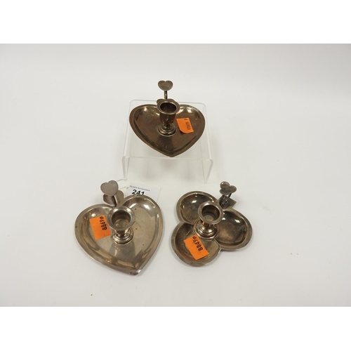 241 - Pair of silver heart shaped small chamber sticks, 1900 and a silver clover leaf patterned small cham... 