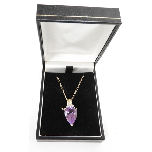 309 - 14ct gold diamond and amethyst pendant supported from a fine chain necklace