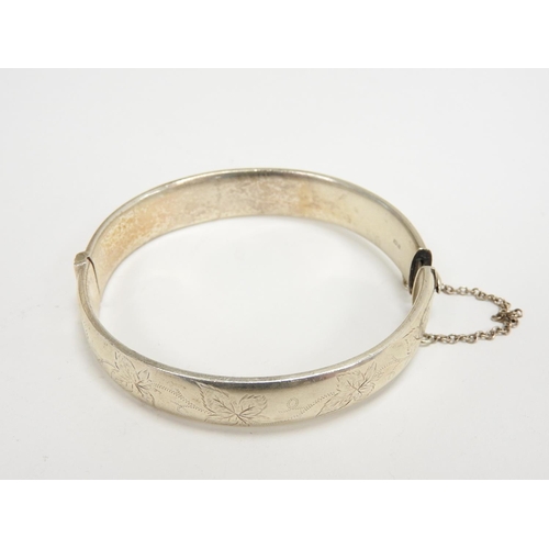 329 - Silver hinged bangle with safety chain