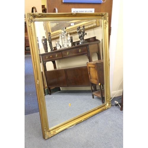 444 - Modern gilt framed bevelled glass wall mirror, 106cm x 129cm