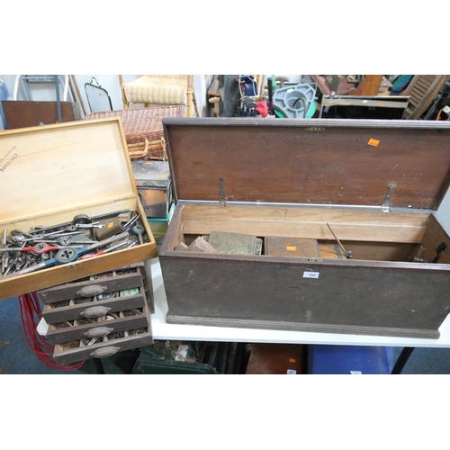 530 - Assorted engineering tools contained within an old wooden box, tap and die sets, small four drawer c... 