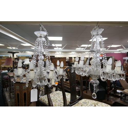 588 - Pair of post-War cut glass eight branch chandeliers with a 72cm drop, 56cm diameter