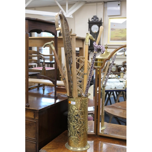 657 - Brass stick stand with assorted walking cane and other contents