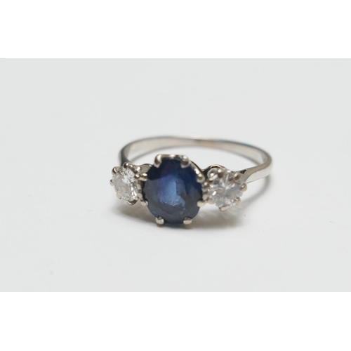 354 - Sapphire and diamond three stone ring, the central oval cut sapphire of approx. 1ct flanked by two r... 