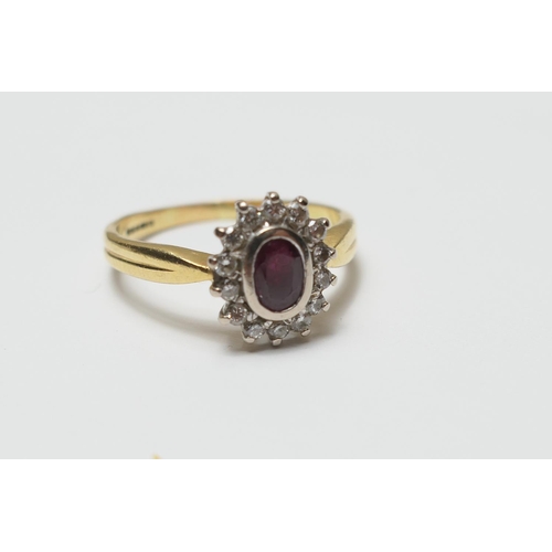 387 - Ruby and diamond cluster ring, the central oval ruby of approx. 0.5ct, bordered with 14 small brilli... 