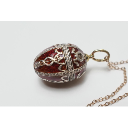 408 - Russian enamelled and diamond egg pendant, with deep red enamelled ground, worked in Imperialist sty... 