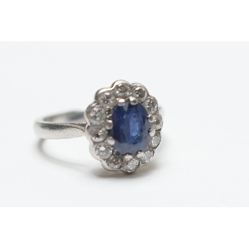 448 - Sapphire and diamond cluster ring, in 950 standard platinum, the oval cut sapphire of approx. 0.75ct... 