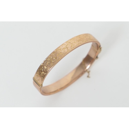 459 - 9ct gold hinged bangle, with foliate chased decoration, cuff size 58mm, weight approx. 10g