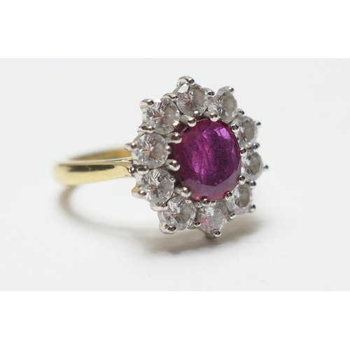 468 - Diamond and ruby cluster ring, the central oval cut ruby of approx. 1ct, bordered with ten brilliant... 