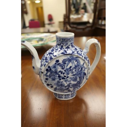 37 - Chinese blue and white wine jug, moon shape decorated with dragons scrolling amidst foliage in under... 