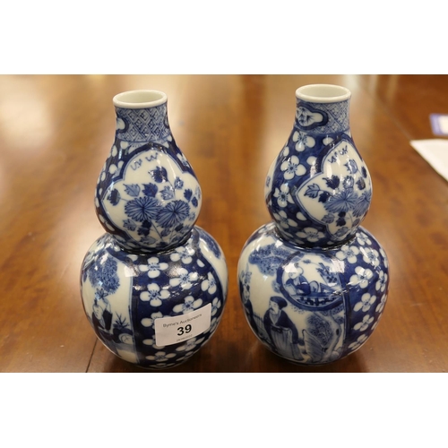 39 - Pair of Chinese blue and white gourd vases, late 19th Century, decorated with figural panels against... 