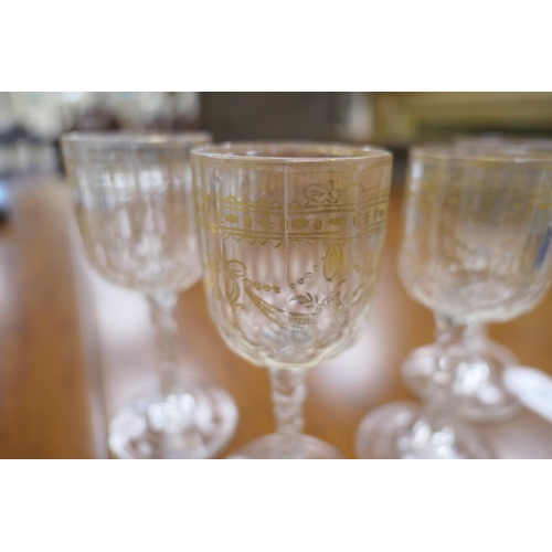 59 - Fifteen Regency gilded and faceted wine glasses, early 19th Century, the bowls decorated with ribbon... 